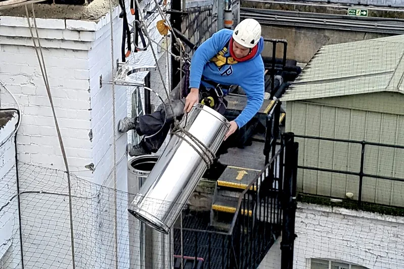 Rope-access installation of insulated twin wall flue system completed without scaffolding